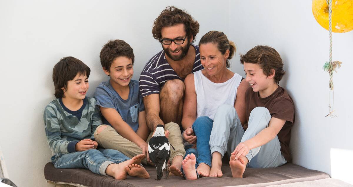 SAVIOUR: The Bloom family with Penguin, the magpie the family nursed back to health, shortly after mum Sam suffered a paralysing fall. Picture: Cameron Bloom
