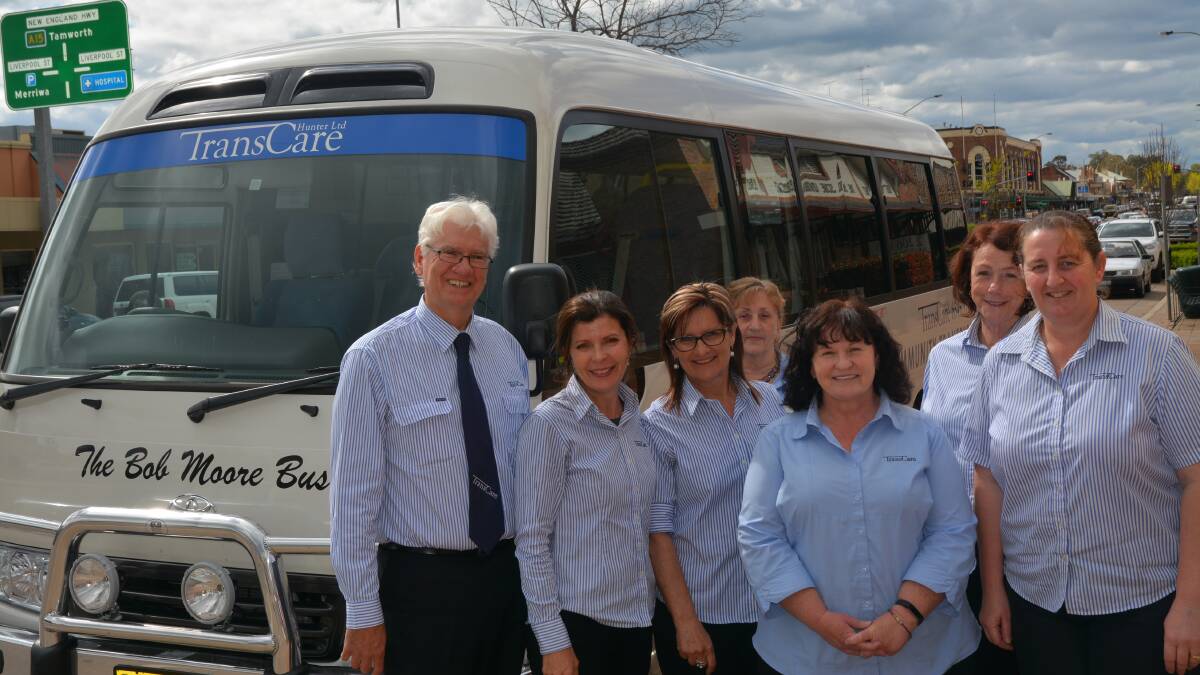 RECOGNITION: TransCare CEO Alan Gordon and staff members next to the new bus on Friday.