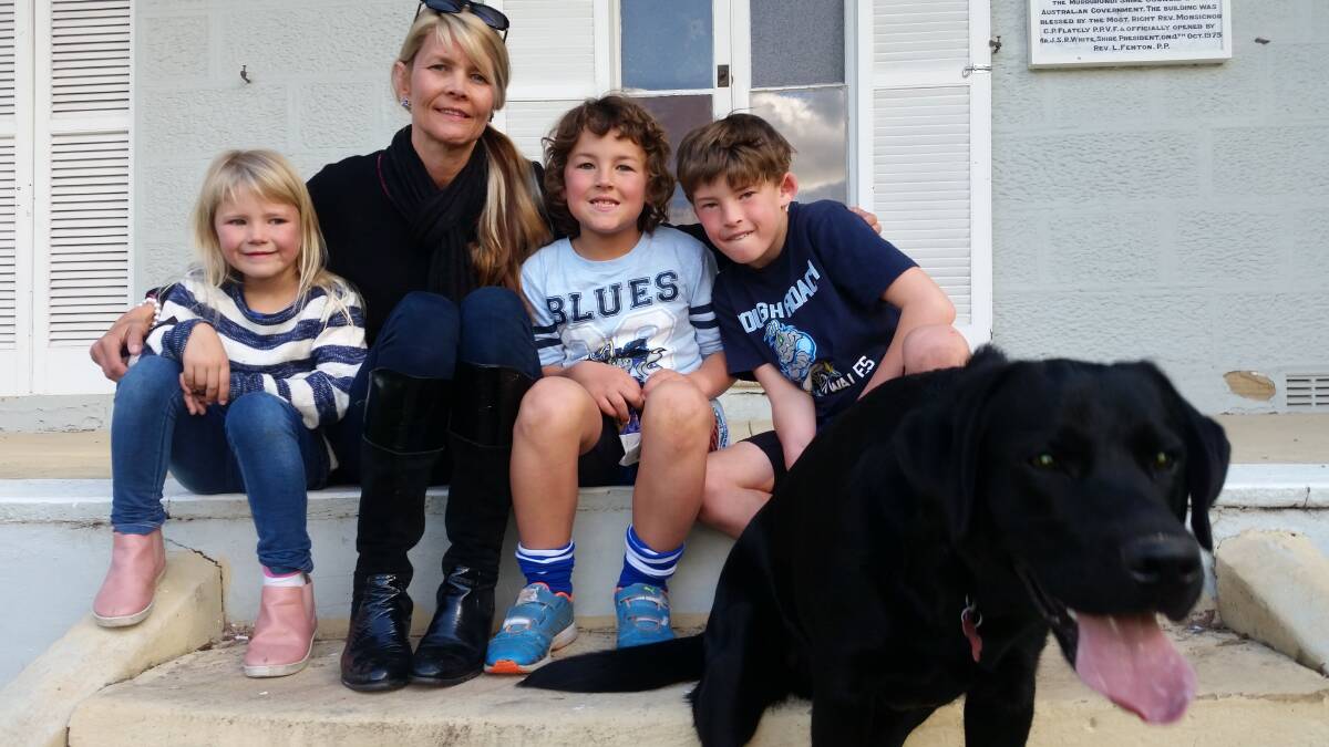 JET-SETTING: The Normans are thrilled to have their nine-month-old labrador, Jet, back home after he went missing for four days.