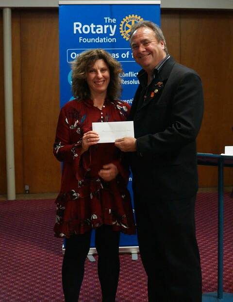 HELPING HAND: Shani Mitchell from Merton Living receives a donation from Denman Rotary's Rod Hirst.