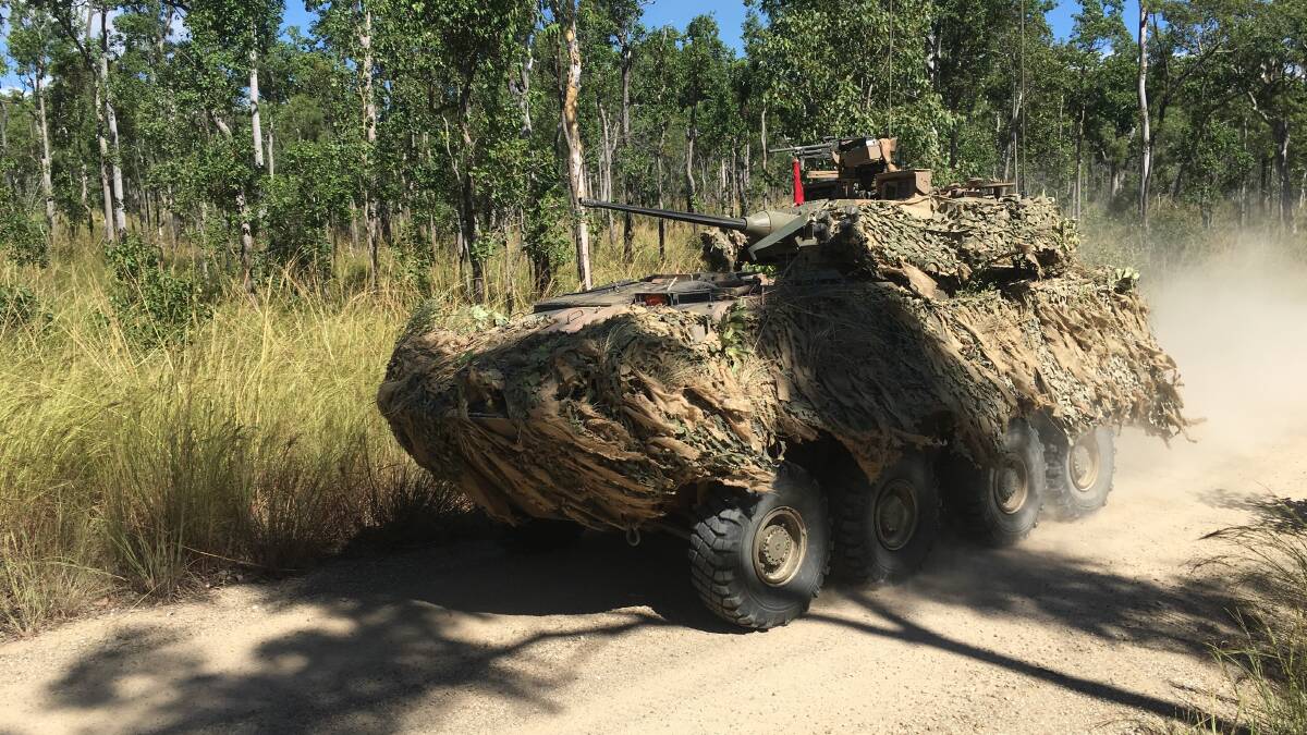 CAMOUFLAGE: An Australian Light Armoured Vehicle (ASLAV) conducts a tactical manoeuvre along a main supply route on Exercise Koster River.