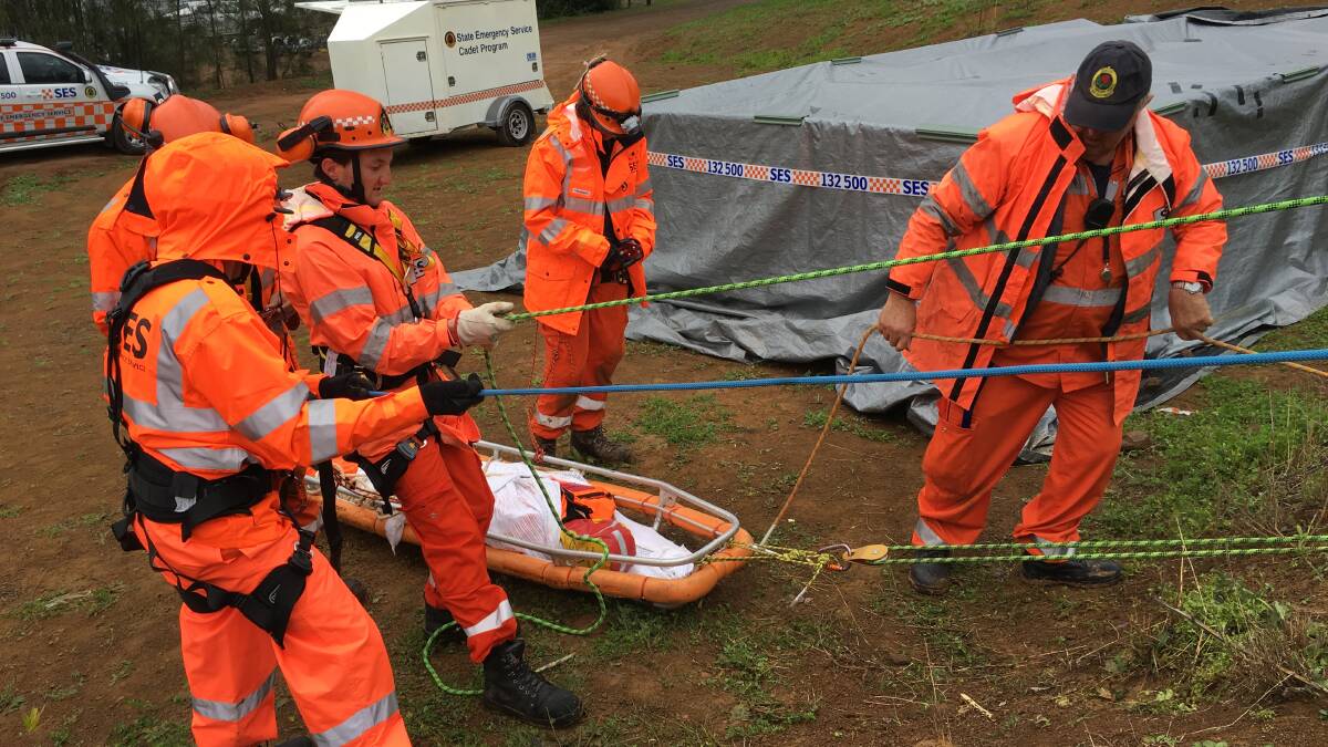 TRAINING: SES volunteers perform a land rescue during Operation Panda at Glenbawn Dam at the weekend.