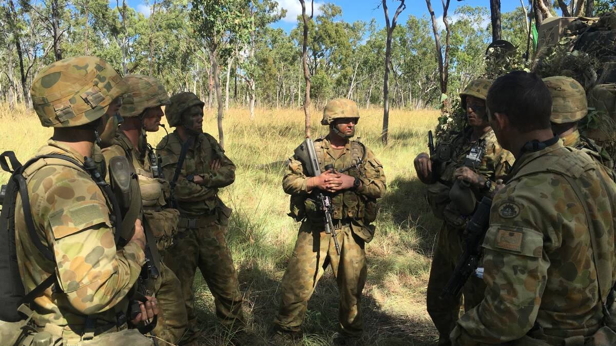 TRAINING TACTICS: V11F going through mission rehearsal discussions prior to conducting a live fire convoy escort task with 2nd/14th Light Horse Regiment (Queensland Mounted Infantry) from left Trooper Patrick Wilson, section second-in-command Trooper Casey Flanagan, Trooper Sam Woods, Trooper Matthew Dale, section commander Lance Corporal Liam O'Brien, Trooper Patrick Flanagan and Trooper Samuel Lewis.