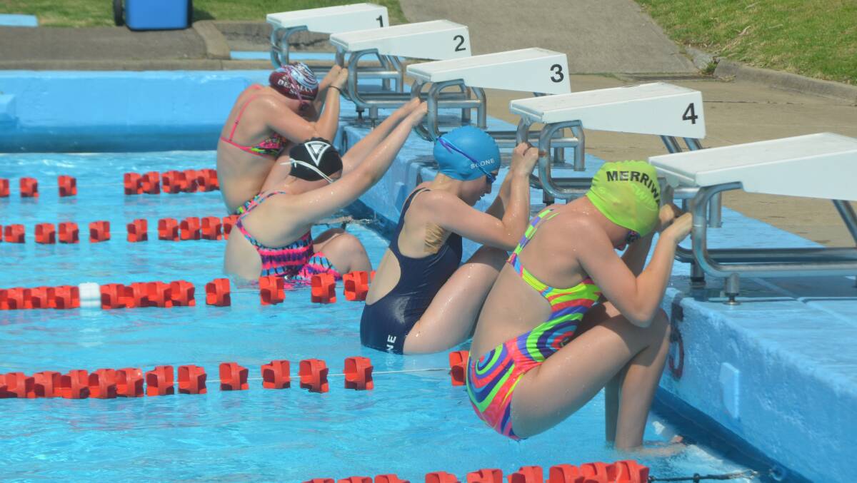 ON YOUR MARKS: Competitors in the girls’ 13 years/under 50m backstroke take their starting position at the Muswellbrook Aquatic Centre on Saturday.
