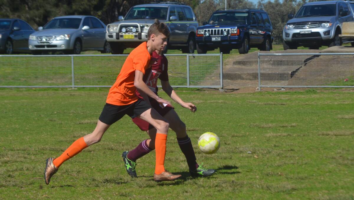 LOCAL DERBY: The Muswellbrook Eagles and Singleton Strikers locked horns in the interdistrict 14 years' football encounter at Victoria Park on Saturday.