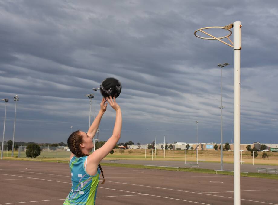 NETBALL IS FUN: Callie Donohue, Gen Youth Glitter Girls, prepares for the 2017 Singleton Netball Association Twilight Competition.