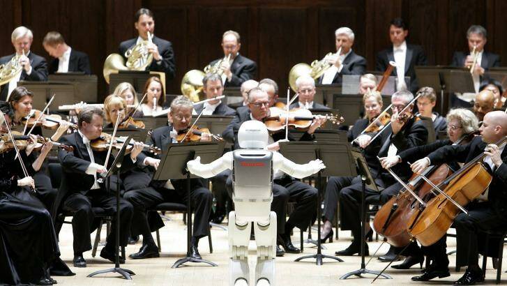 Mechanical maestro: a robot conducts an orchestra. Photo: Paul Sancya