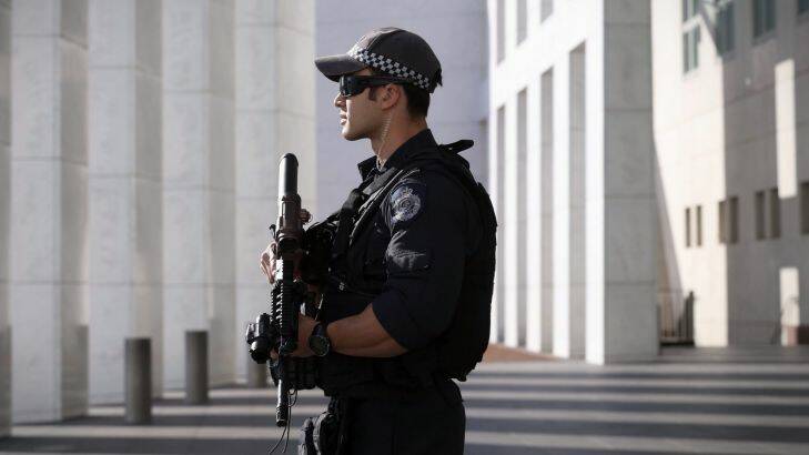 An AFP officer armed with an SR-16 stands guard to the front of Parliament House in Canberra on Thursday 23 October 2014. Photo: Andrew Meares