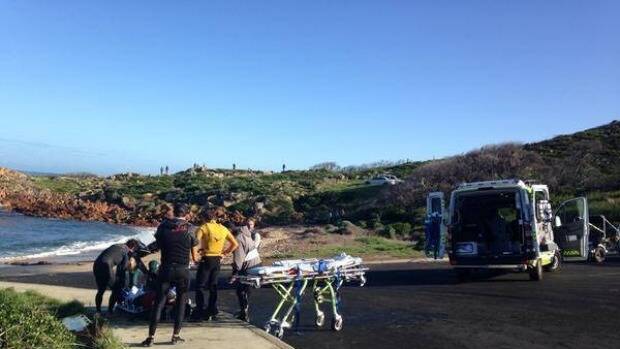 Justin Holland receives medical attention after he wiped out at famous Gracetown surf break Photo: @Roxanne_Taylor, ABC News.