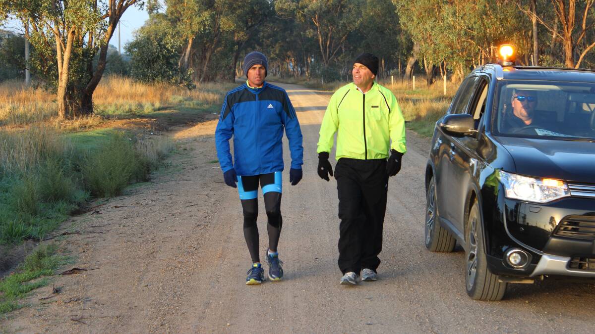 CHILLY START: Tim Blair and Shane Taylor all rugged up trying to get some kilometres in during yesterday morning’s three degree temperature.
