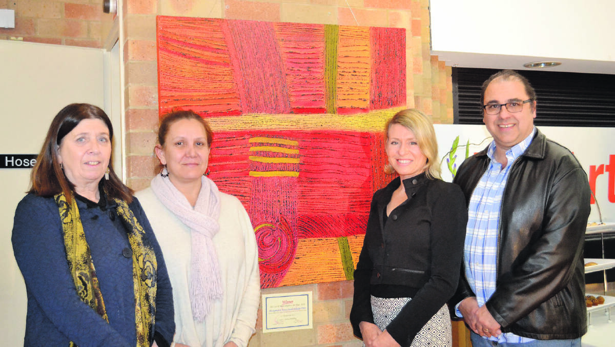SHOWCASE: From left, Aboriginal community representative for the Coal & Allied Aboriginal Community Development Fund (ACDF) Deidre Heitmeyer, artist Saretta Fielding, Aboriginal relations specialist
and Coal & Allied ACDF executive officer Cate Sims and Aboriginal community representative for the Coal & Allied ACDF Brad Franks stand with the artwork Koyiyoong Campsite, which took out the Aboriginal art category. 