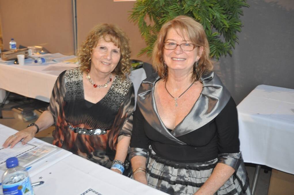 Volunteers Julie Osborn, from Muswellbrook, (left) and Victoria Ryan, also from Muswellbrook, who spent almost the entire evening at the ticket sales and raffle table.