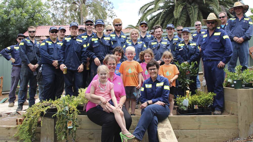 GROWING: Muswellbrook Preschool students Ellie Loose, Riley Francis, Caleb McTaggart, Molly Medhurst and Bette Lysaught, with Muswellbrook 
Preschool director Kelly Constable, Bengalla general manager operations 
Jo-Anne Scarini, and Bengalla apprentices and maintenance staff who helped construct the garden.
