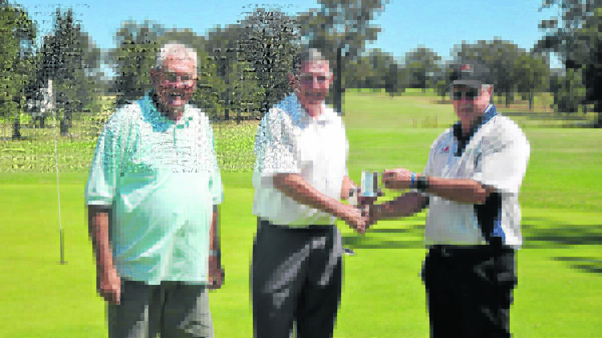 ALL SMILES: Denman Golf Club president Les Eaton, recipient of the monthly mug David Roe, and vice captain Denis Chandler.