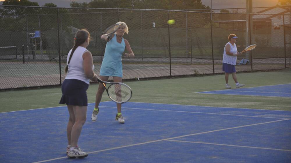WORKING HARD: Helen Burge hits a return while Wendy Izzard looks on during the Scone Hardcourt Tennis Association’s ladies competition.