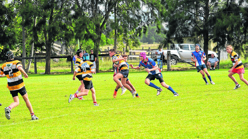 HARD TO STOP: Central North’s under-14 player Matt Smart runs at the Hunter defence.
