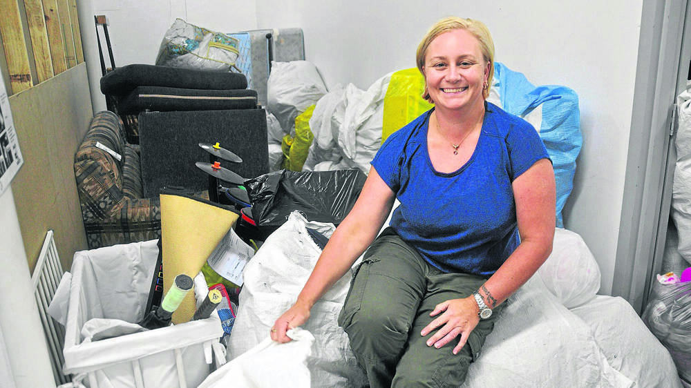 GENEROUS: Lifeline’s store manager in Muswellbrook, Annie, swamped by the donations received from people in the Upper Hunter in the past week.