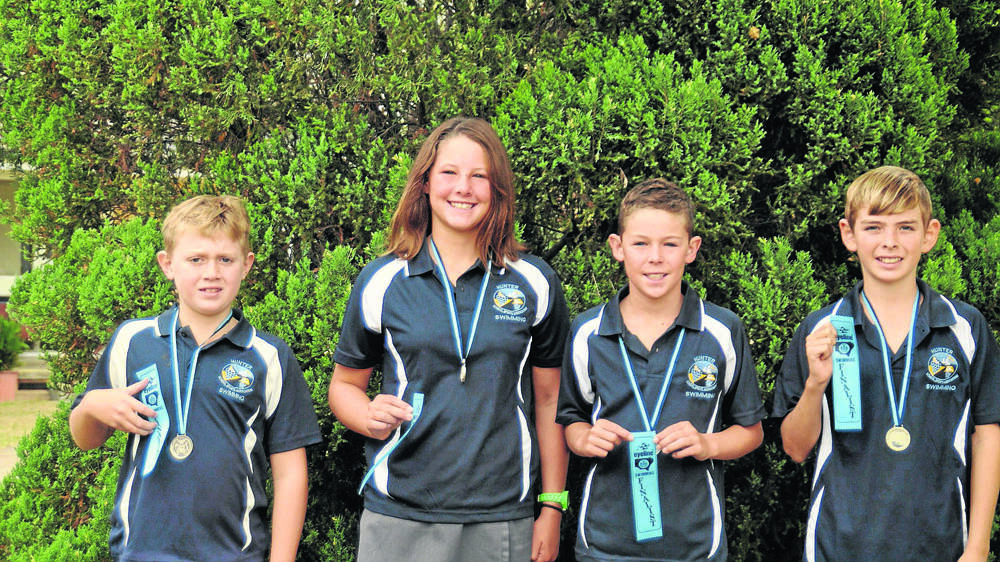 GREAT EFFORT: Sandy Hollow students Andrew Harris, Amy Thompson, Sam Thompson and Angus Higgins with their medals and ribbons from the PSSA state carnival.