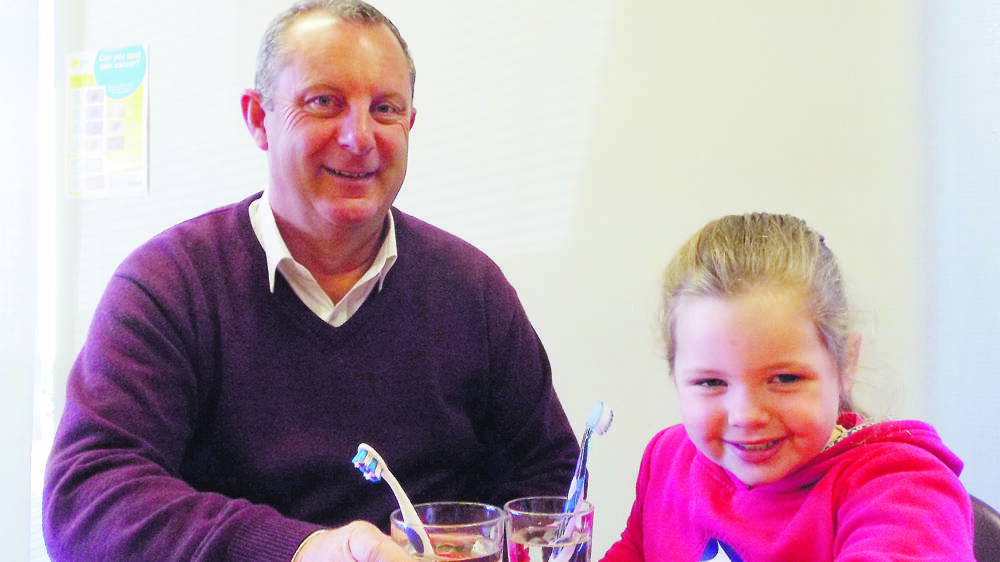CHEERS: Upper Hunter Shire mayor Michael Johnsen and four-year-old Molly McCosker toast the move to fluoridate town water in the next few years.
