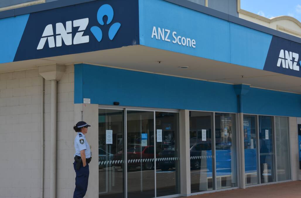 ARMED ROBBERY: Police guard the ANZ bank in Kelly St, Scone, after a robbery on Friday morning. Pic: BEN MURPHY.