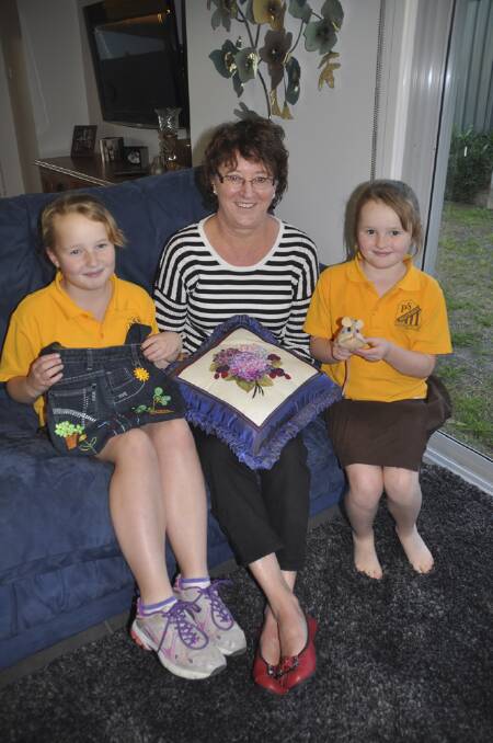 FINE WORK:  Lyn Hiscox’s handcraft does much to inspire students Katie McKay (left) and sister Sarah who will both be entering Singleton Show.