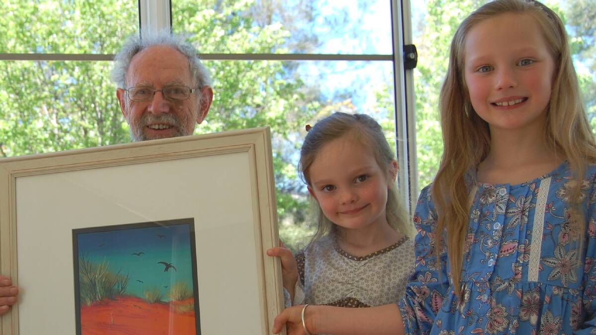 GOOD CAUSE: Ted Finnie with Arlia and Helena Parker and Central Desert Landscape which will be won at Merriwa Show.