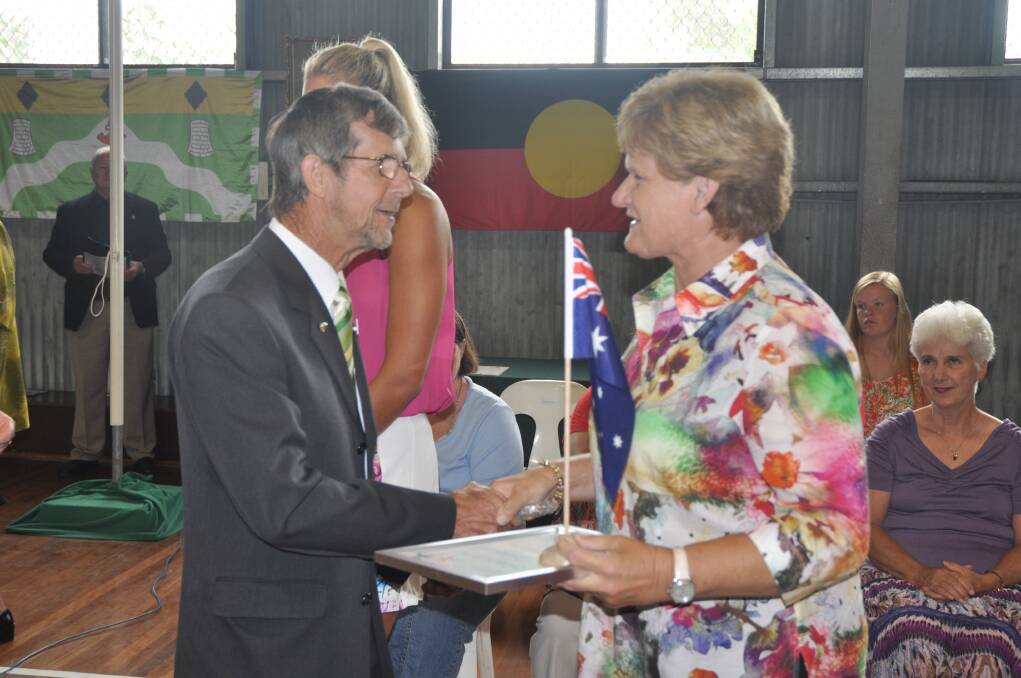 PASSING THE BATON: 2013 Muswellbrook Shire Citizen of the Year Graham Turvey congratulates Jenny Hinschen on being named 2014 Citizen of the Year at Denman on Sunday.