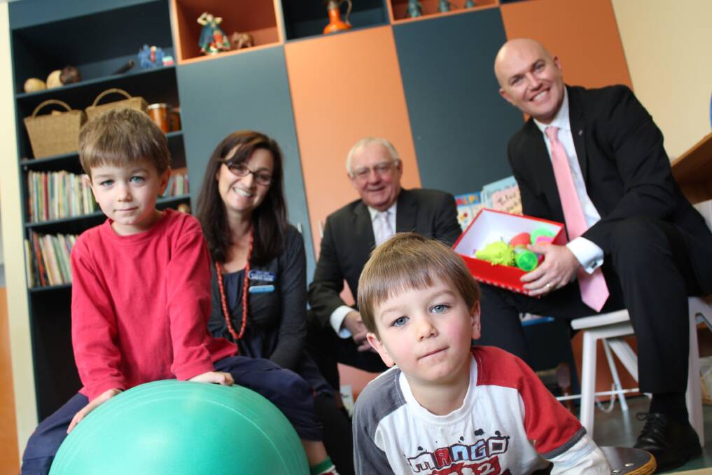 INNOVATIVE: Twins Lewis and Noah with aides from the Wiggle Jiggle Roll  and Sit kits, joined by Early Links occupational therapist Annette Collins, Newcastle Permanent Charitable Foundation chairman Michael Slater (centre) and executive officer Jason Bourke.