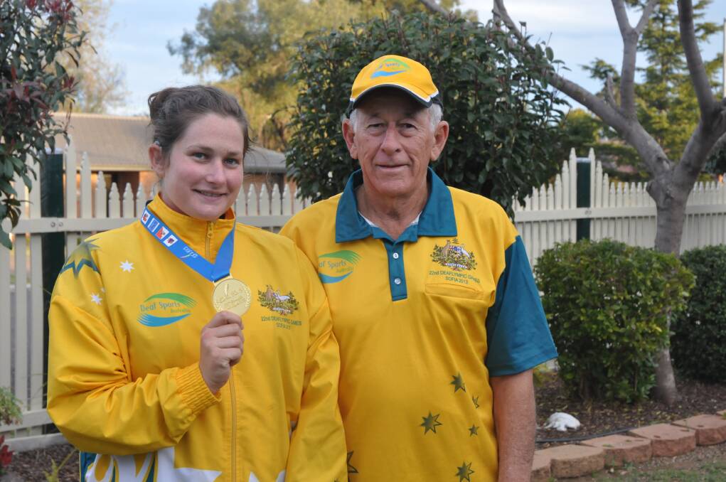 SOLID GOLD EFFORT: Talented athlete Amy-Lea Mills was delighted to bring home Australia’s only gold medal from the recent Deaflymics, as was her proud grandfather and coach George McCready.