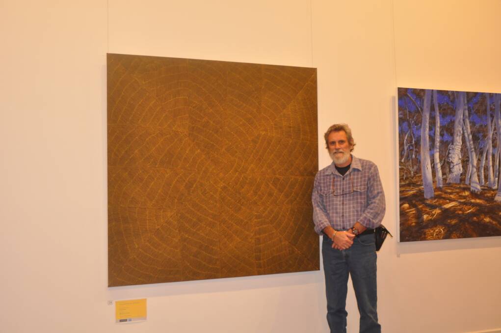 MARCH: WINNING COMBINATION: Muswellbrook Regional Arts Centre education officer Roger Skinner with Margaret Loy Pula’s work Anatye – Bush Potato, which won the 42nd Muswellbrook Art Prize on Saturday night.