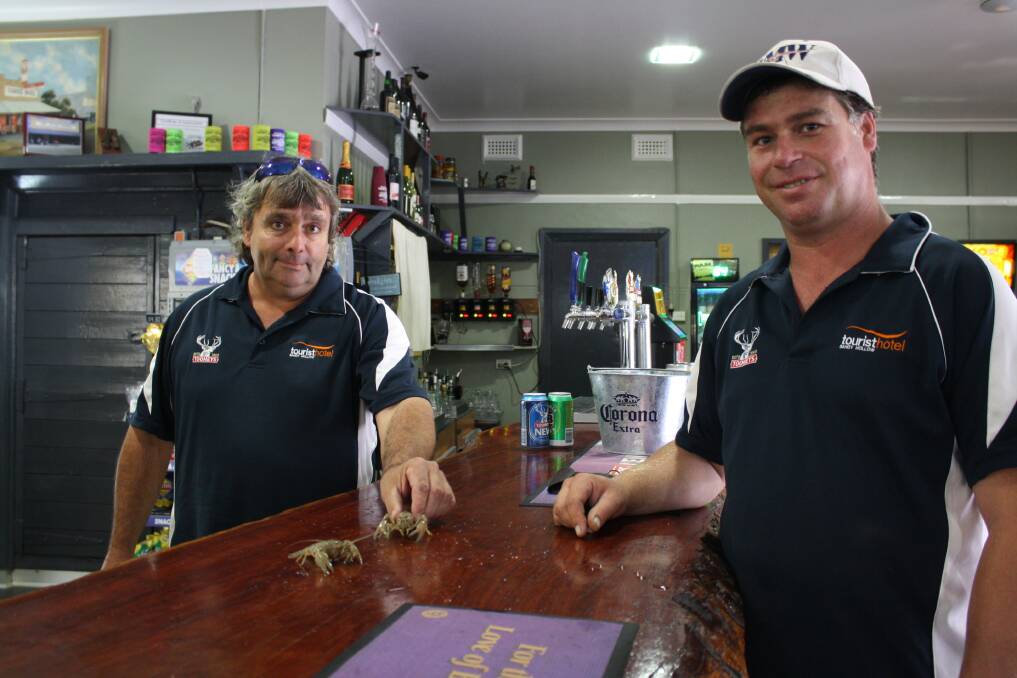 DECEMBER: PINCING A WINNER: Tourist Hotel, Sandy Hollow, staff member Mark Rawnsley and manager Ben Wallace prepare some of the competitors for the annual Yabby Races.