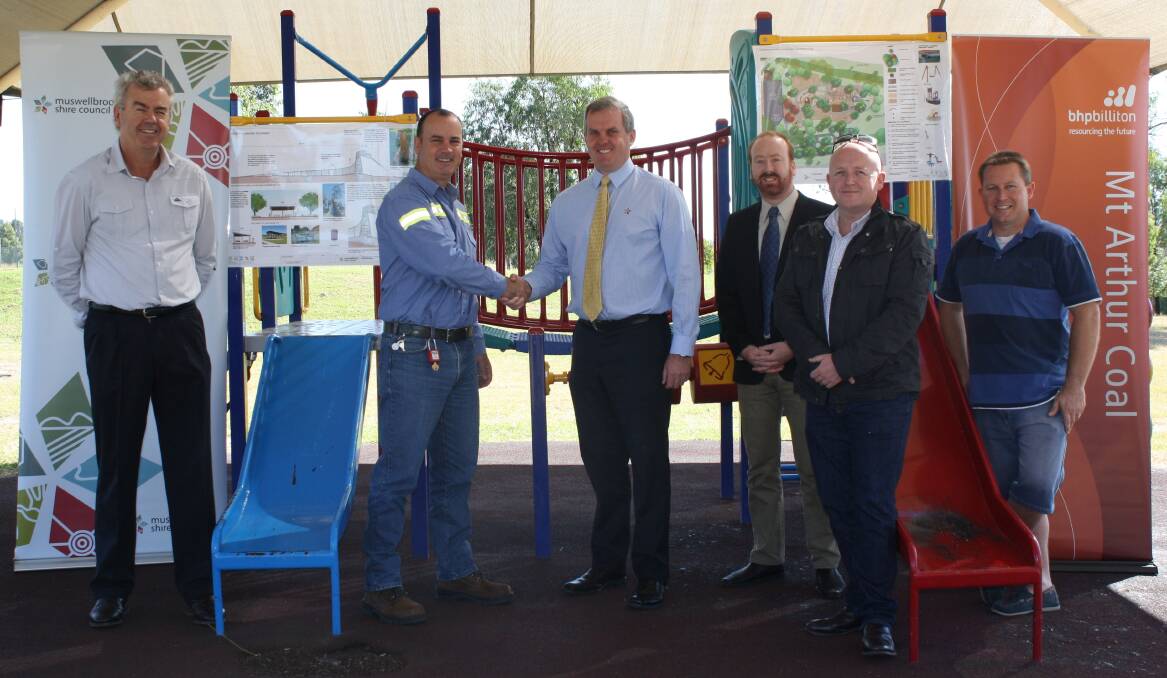 MAY: PARTNERSHIP:From left, Muswellbrook Shire councillor Graham McNeill, BHP Billiton NSW Energy Coal Asset president Peter Sharpe, who is shaking hands with Muswellbrook Shire Council general manager Steve McDonald, mayor Martin Rush, the architect who designed the new playground’s look David Moir and Mt Arthur Coal community investment fund member Tim Troon. Behind them are the conceptual designs for the new playground, which were unveiled last week at Highbrook Park to a crowd of community members.