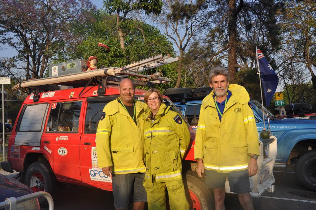 COLOURFUL: Brisbane trio Darren Redsell, Trina Redsell and Laurie Redsell with their makeshift “fire truck” at Simpson Park, Muswellbrook.