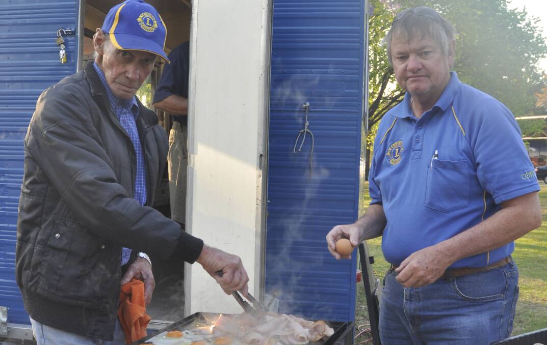 MASTER CHEFS: Ken Paton and Mark Elsey, and their fellow Muswellbrook Lions, ensure that no-one was left unfed during the stopover.