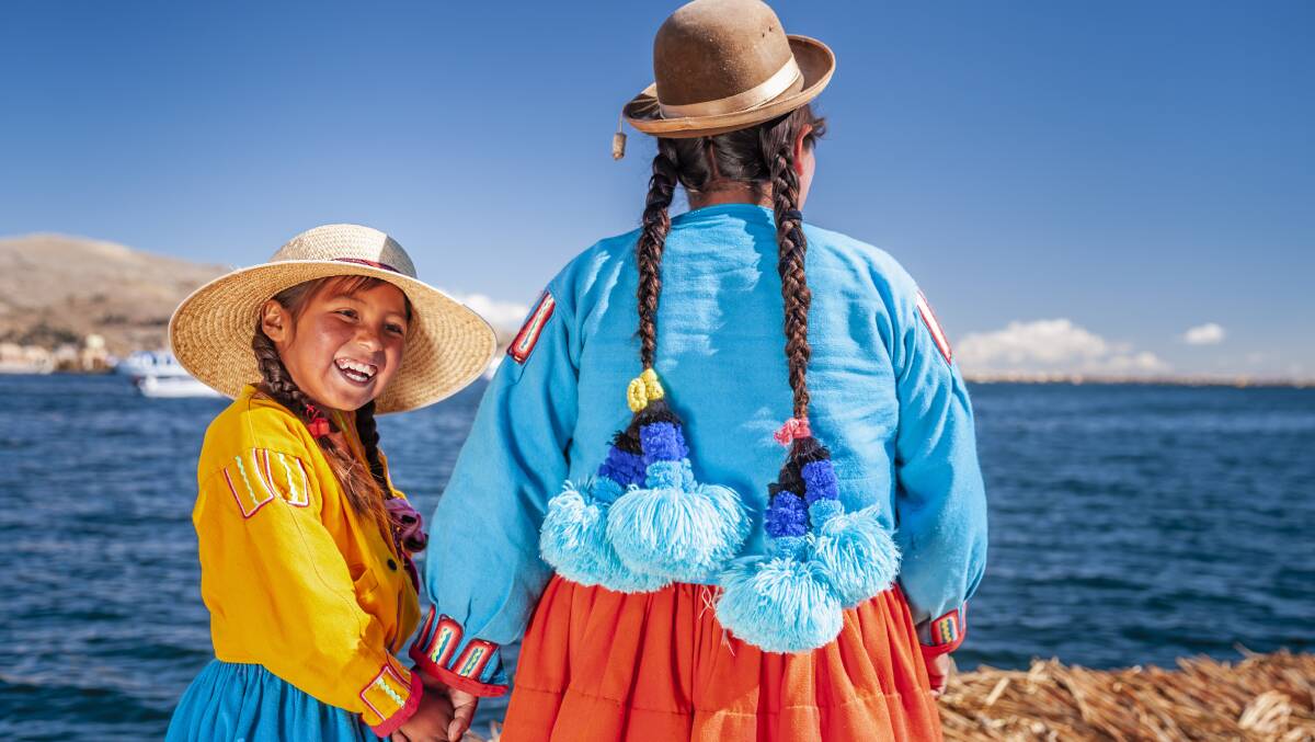 A mother on daughter on a floating island of Lake Titicaca, Peru. Picture: Getty Images