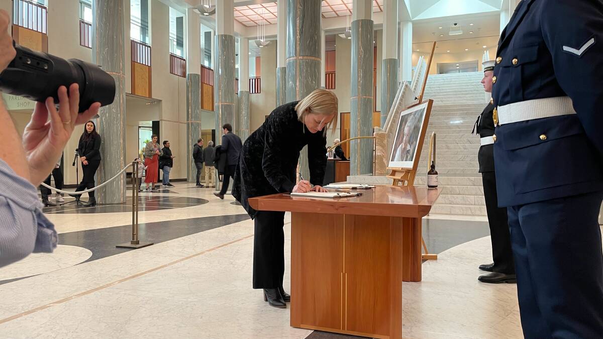 Katy Gallagher, pictured signing a condolence book, says the Queen's service should be acknowledged before a debate on the republic. Picture: Finn McHugh