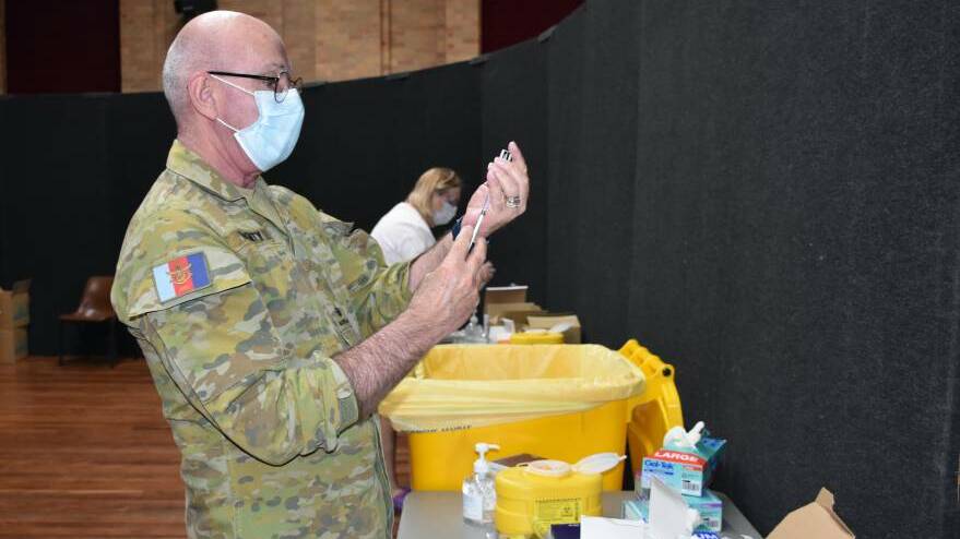 Major Peter McGinty, Health Centre manager, Lone Pine Barracks, Singleton draws a shot of vaccine at Sunday's walk-in vaccination clinic at the Civic Centre.