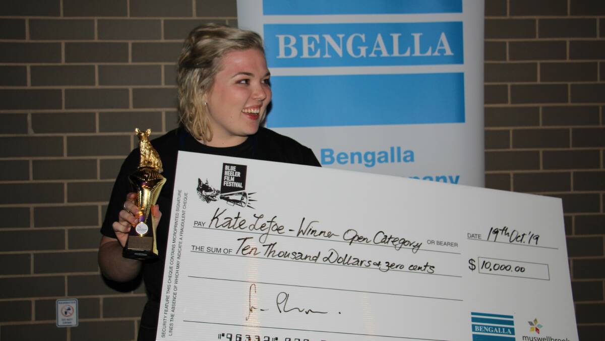 PRIZES: UoN student Brooke Saide accepting an award on behalf of Kate Lefoe, the winner of the 'Golden Bluey' and the Open Category at the 2019 Blue Heeler Film Festival. Supplied: BHFF