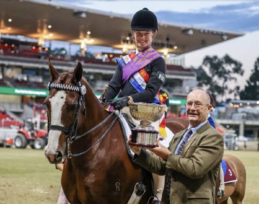 CHAMPION: Scone's Olivia Thrift receiving the George D Scales Memorial Perpetual Trophy as the Champion Pony Club Rider at the 2022 Sydney Royal Easter Show. Picture: Supplied