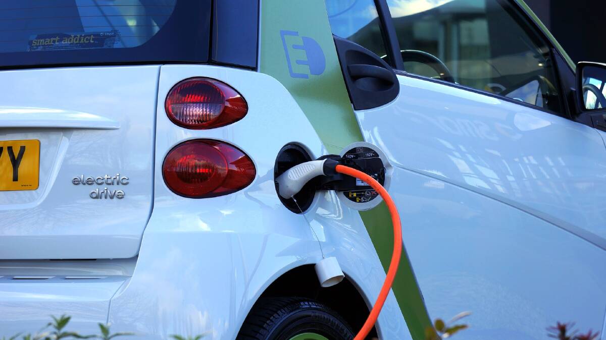 EV: An electric vehicle connected to a charger. 