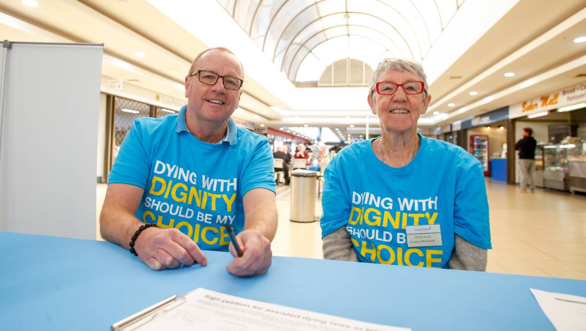 STATEWIDE CAMPAIGN: Illawarra Dying with Dignity supporters Richard Martin and Liz Jacka asking people to sign a petition in support of assisted dying law reform. Picture: Anna Warr