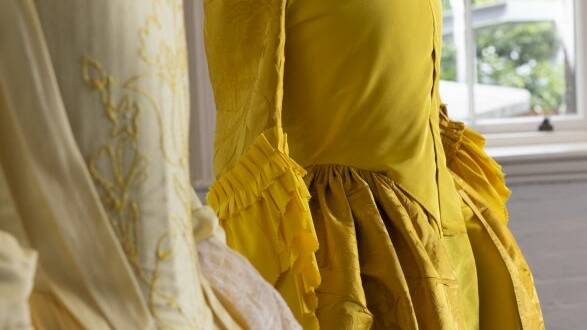 The 280-year-old yellow silk dress (right) and its replica (left). Picture by Jacquie Manning.