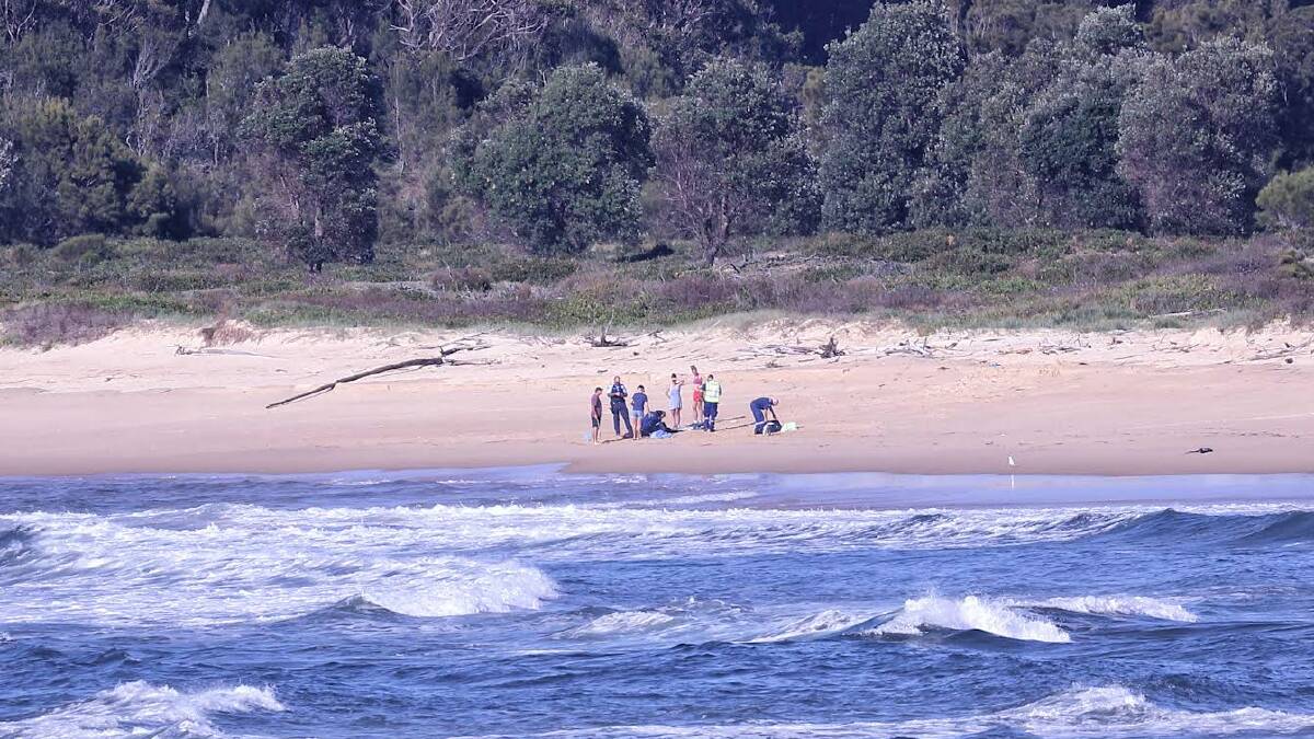 Paramedics and The Toll helicopter crew on the beach near Beachcomber Holiday Park, Potato Point. Picture by Maree Jackson.
