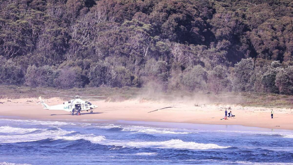 The Toll helicopter helping the man and his son on the beach near Beachcomber Holiday Park, Potato Point. Picture by Maree Jackson.