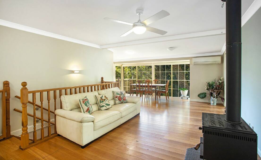 The open-plan living and dining room has a combustion fireplace. Picture supplied
