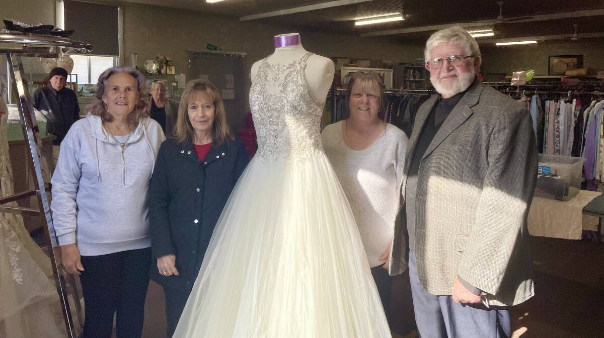Volunteers Sandra Alloway, Janell Atkins, Sharron Earl and Father Carl Lanham with one of the designer wedding dresses at the bridal fair. Picture by Laura Rumbel