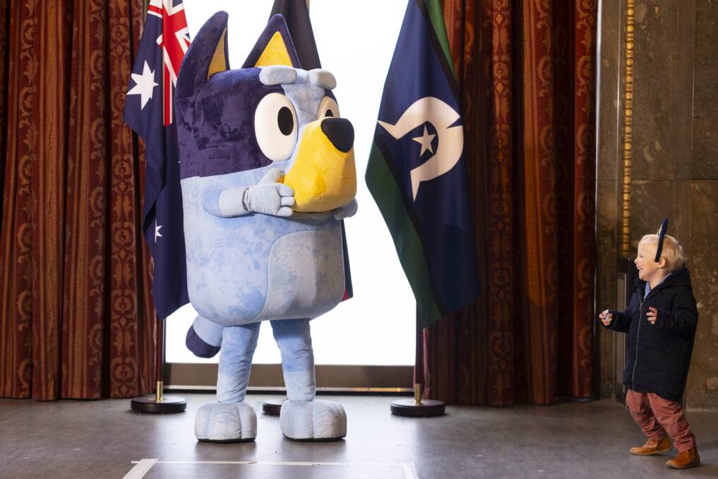 Bluey greets a young fan at the renamed Australia House in London. Picture by Australian High Commission in the United Kingdom/Facebook