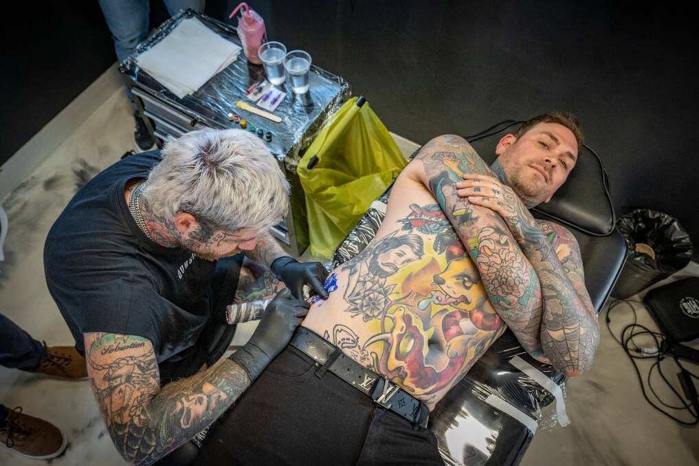 Launceston Mayor Matthew Garwood gets his AFL Tasmania devil tattooed by Aaron Lister of Dorsia Tattoos. 