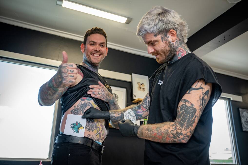 Launceston Mayor Matthew Garwood gets his AFL Tasmania devil tattooed by Aaron Lister of Dorsia Tattoos. Pictures by Paul Scambler