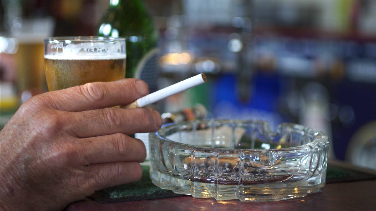Person holding cigarette at a bar. File picture